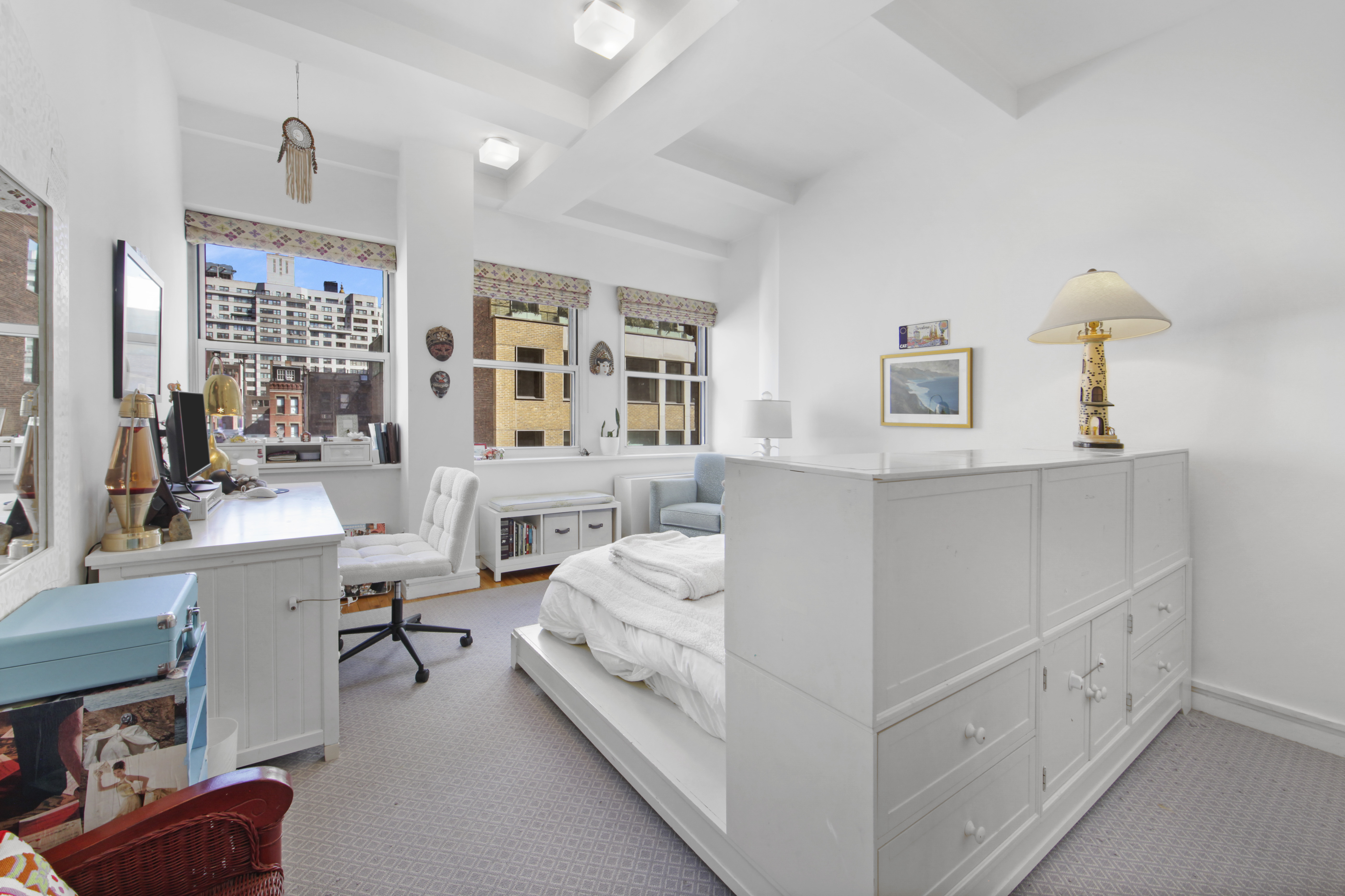 18 East 12th Street, Unit 7BC Manhattan, NY 10003 - Photo 14 of 26 a bedroom with furniture and a lamp