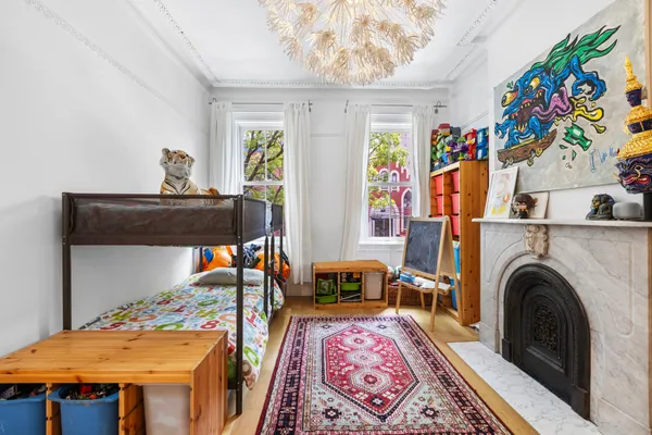 a living room with furniture a flat screen tv and floor to ceiling window