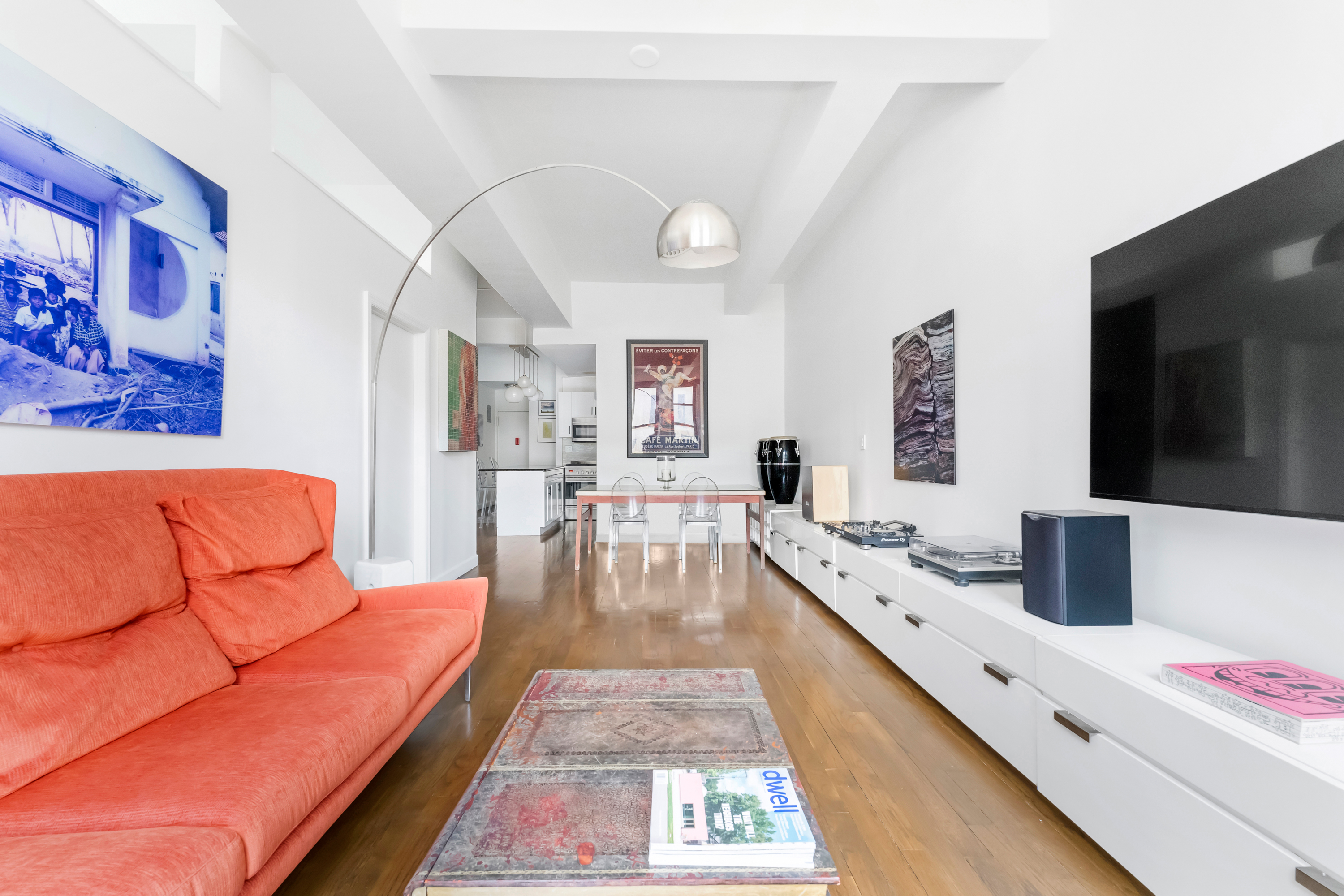 315 7th Avenue, Unit 5C Manhattan, NY 10001 - Photo 2 of 7 a living room with furniture and a flat screen tv
