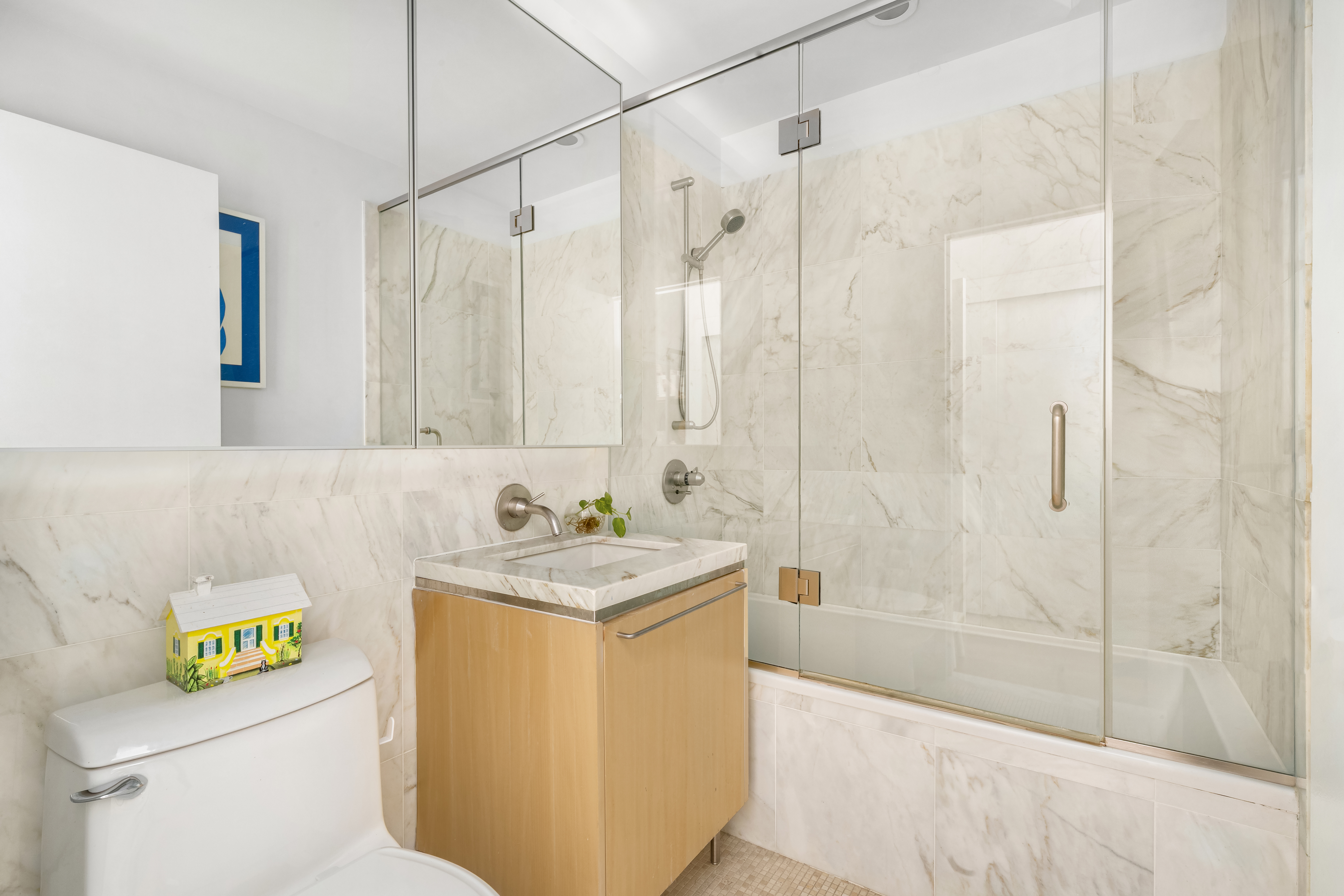 200 Chambers Street, Unit 25F Manhattan, NY 10007 - Photo 12 of 13 a bathroom with a sink a toilet and shower