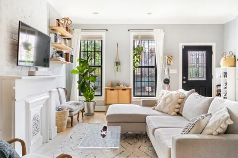 a living room with furniture a flat screen tv and a fireplace