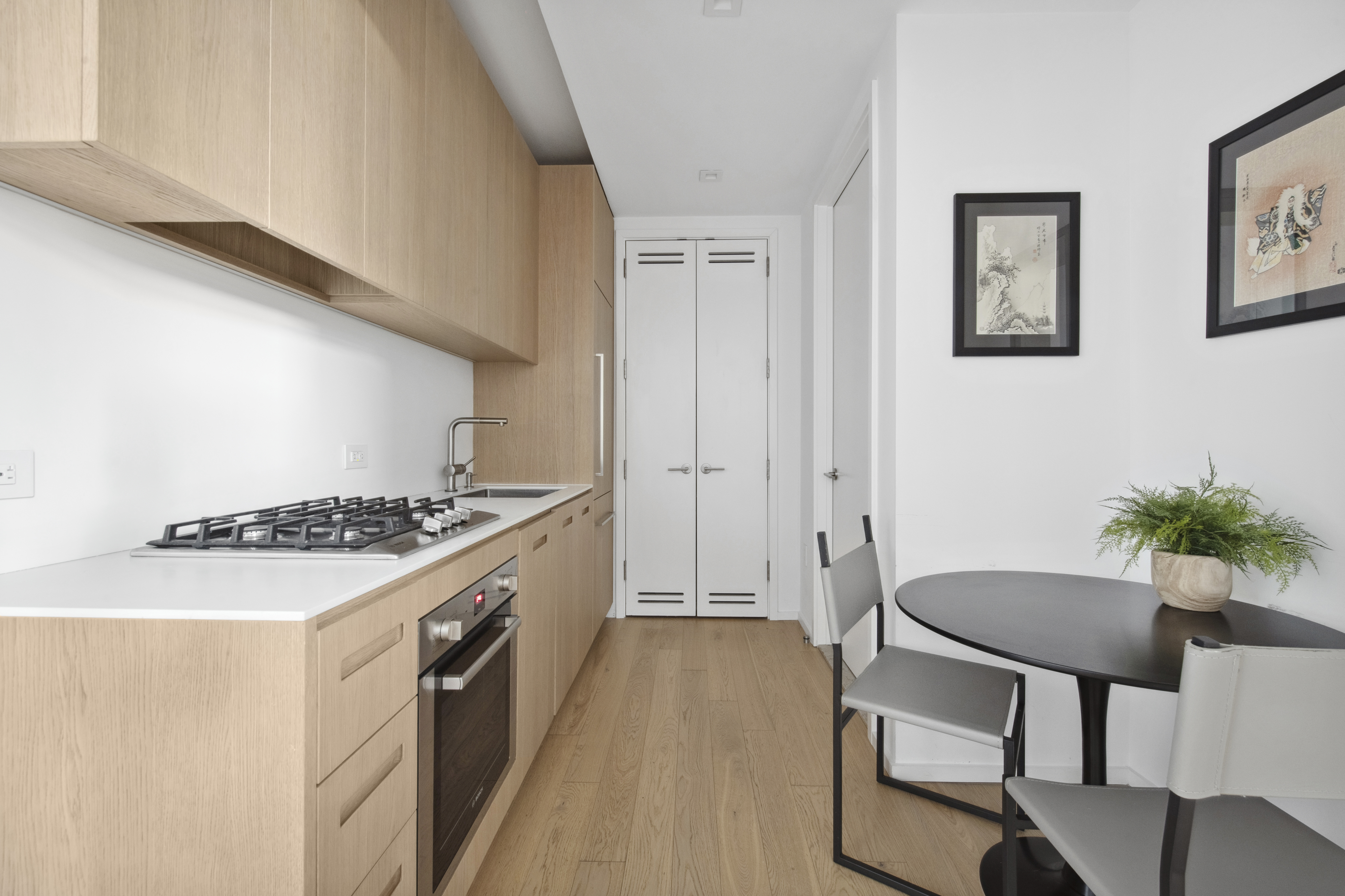 98 Front Street, Unit 9S Brooklyn, NY 11201 - Photo 3 of 7 a kitchen with furniture and a stove