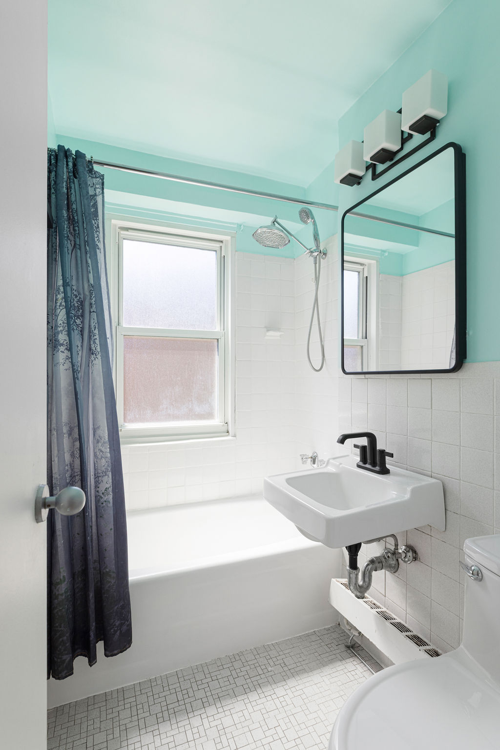 101 West 12th Street, Unit 5V Manhattan, NY 10011 - Photo 16 of 26 a bathroom with a tub sink and a mirror