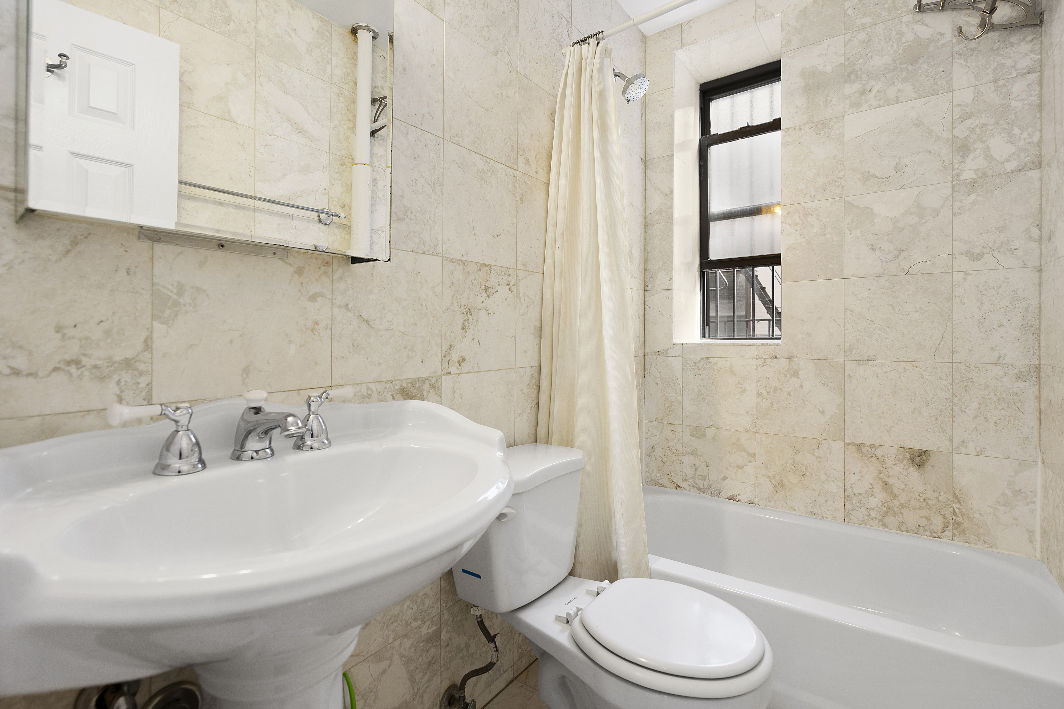 26 Butler Place, Unit 39 Brooklyn, NY 11238 - Photo 4 of 6 a bathroom with a sink toilet and shower