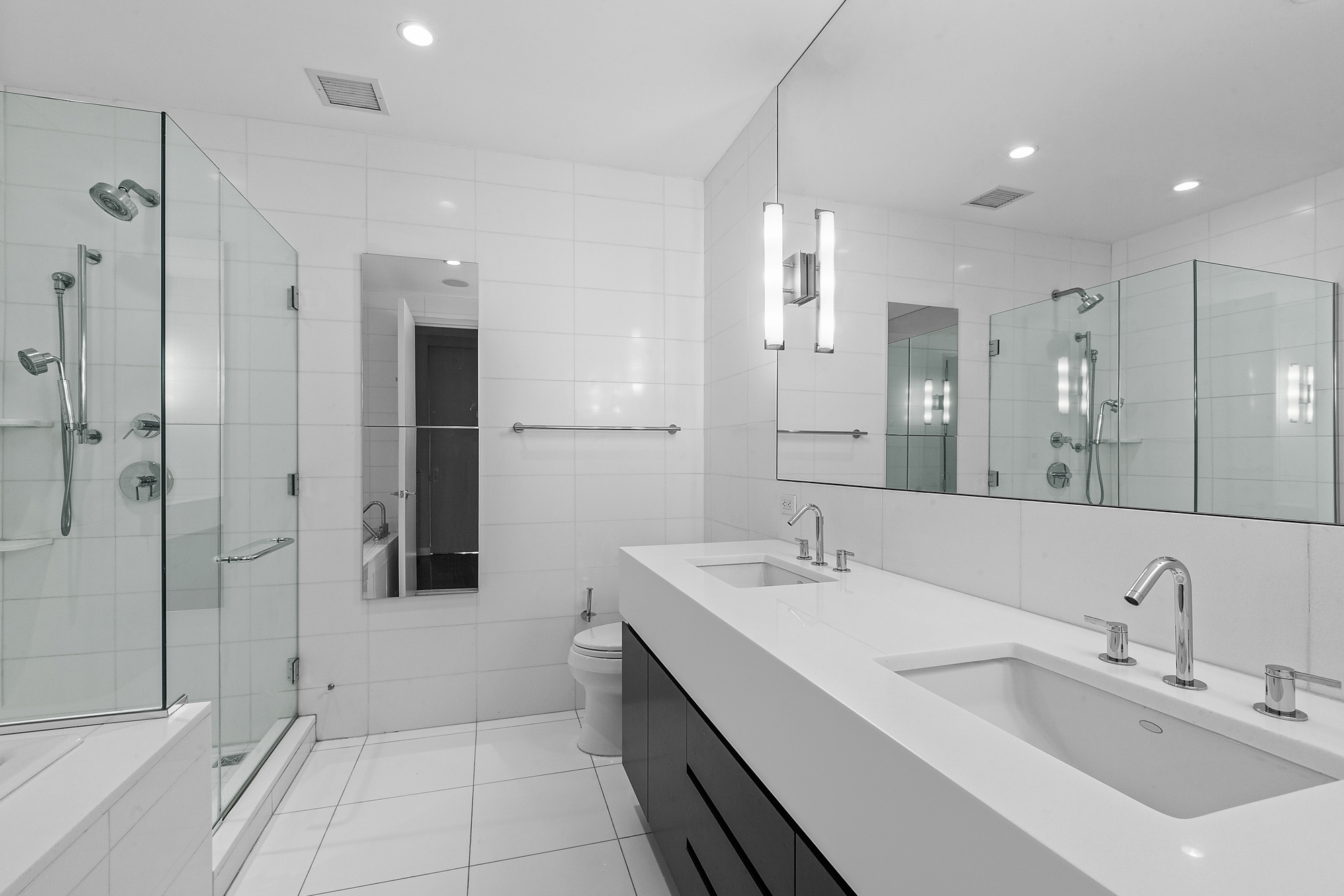 4 West 21st Street, Unit 11A Manhattan, NY 10010 - Photo 8 of 9 a spacious bathroom with a double vanity sink mirror and shower