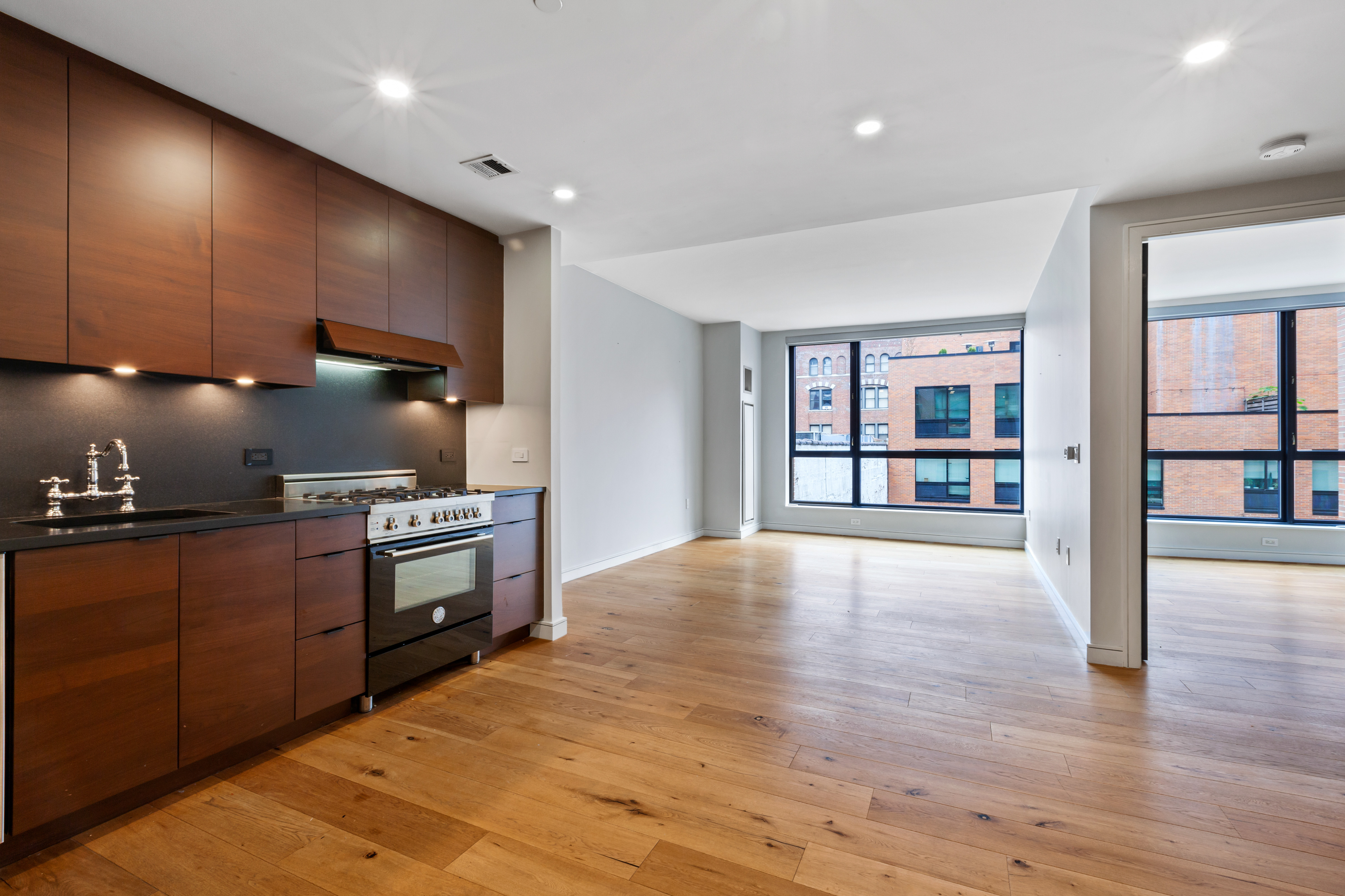 540 West 28th Street, Unit 4F Manhattan, NY 10001 - Photo 5 of 16 a kitchen with stainless steel appliances granite countertop a refrigerator and a stove top oven