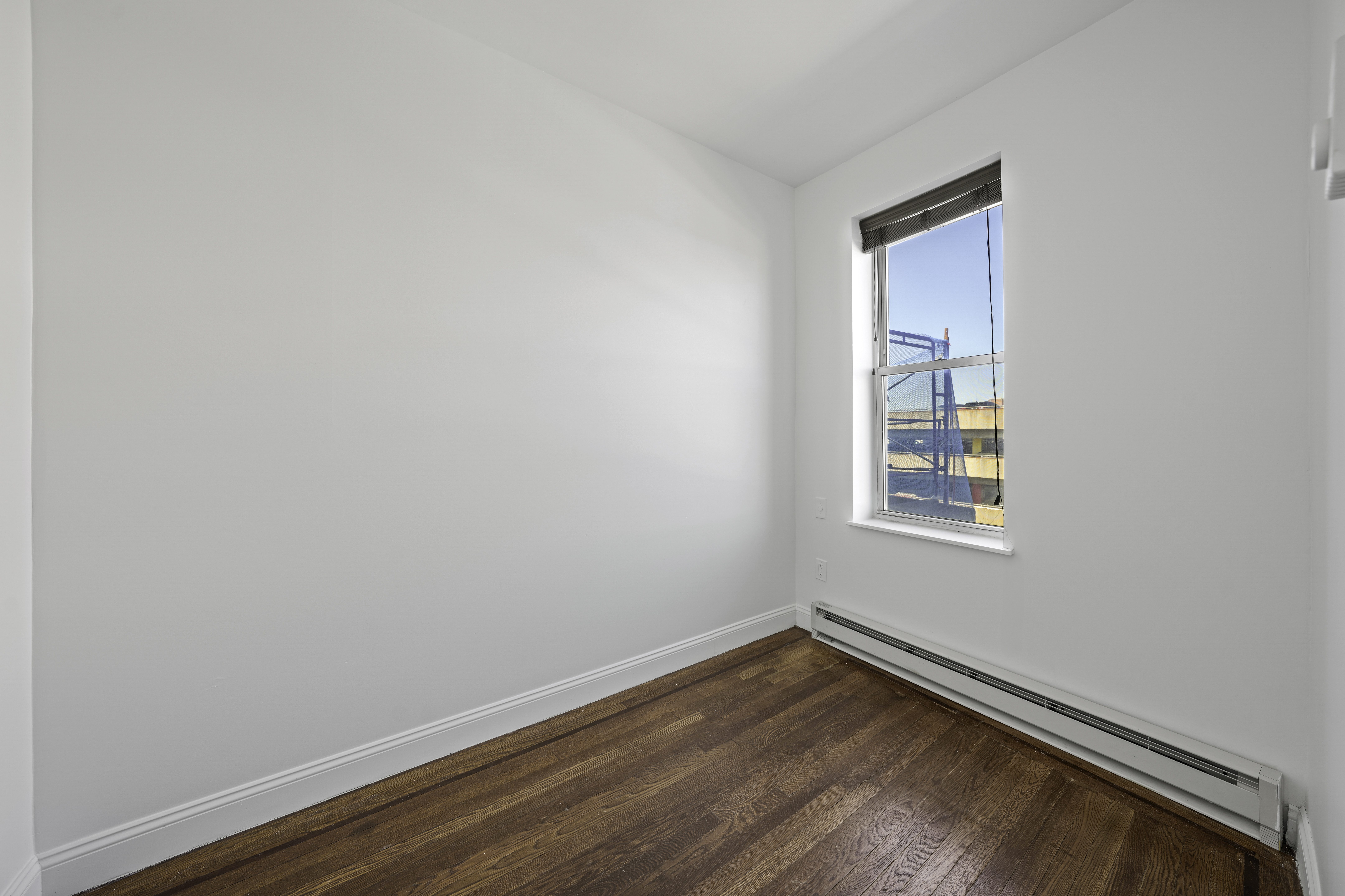 514 86th Street, Unit 4 Brooklyn, NY 11209 - Photo 12 of 19 an empty room with wooden floor and windows
