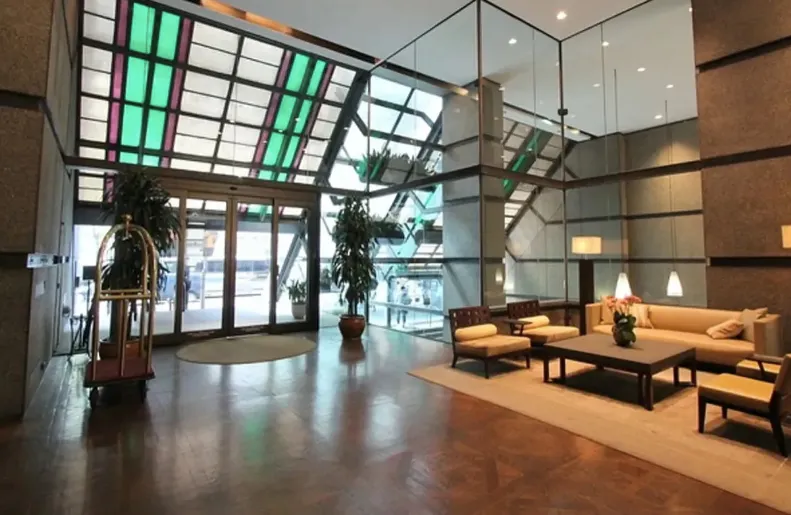 a lobby with furniture and floor to ceiling windows