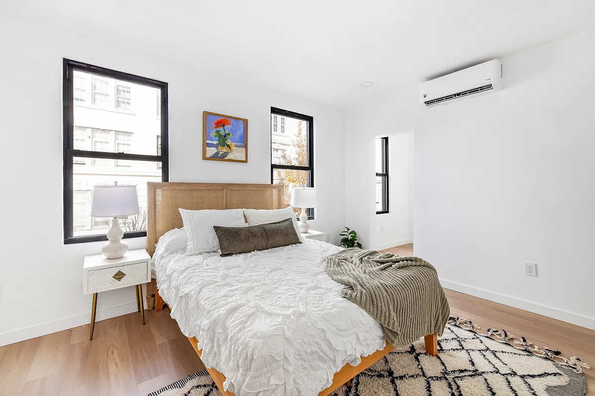 76 Meserole Avenue, Unit 2A Brooklyn, NY 11222 - Photo 7 of 10 a bed room with a bed and a window