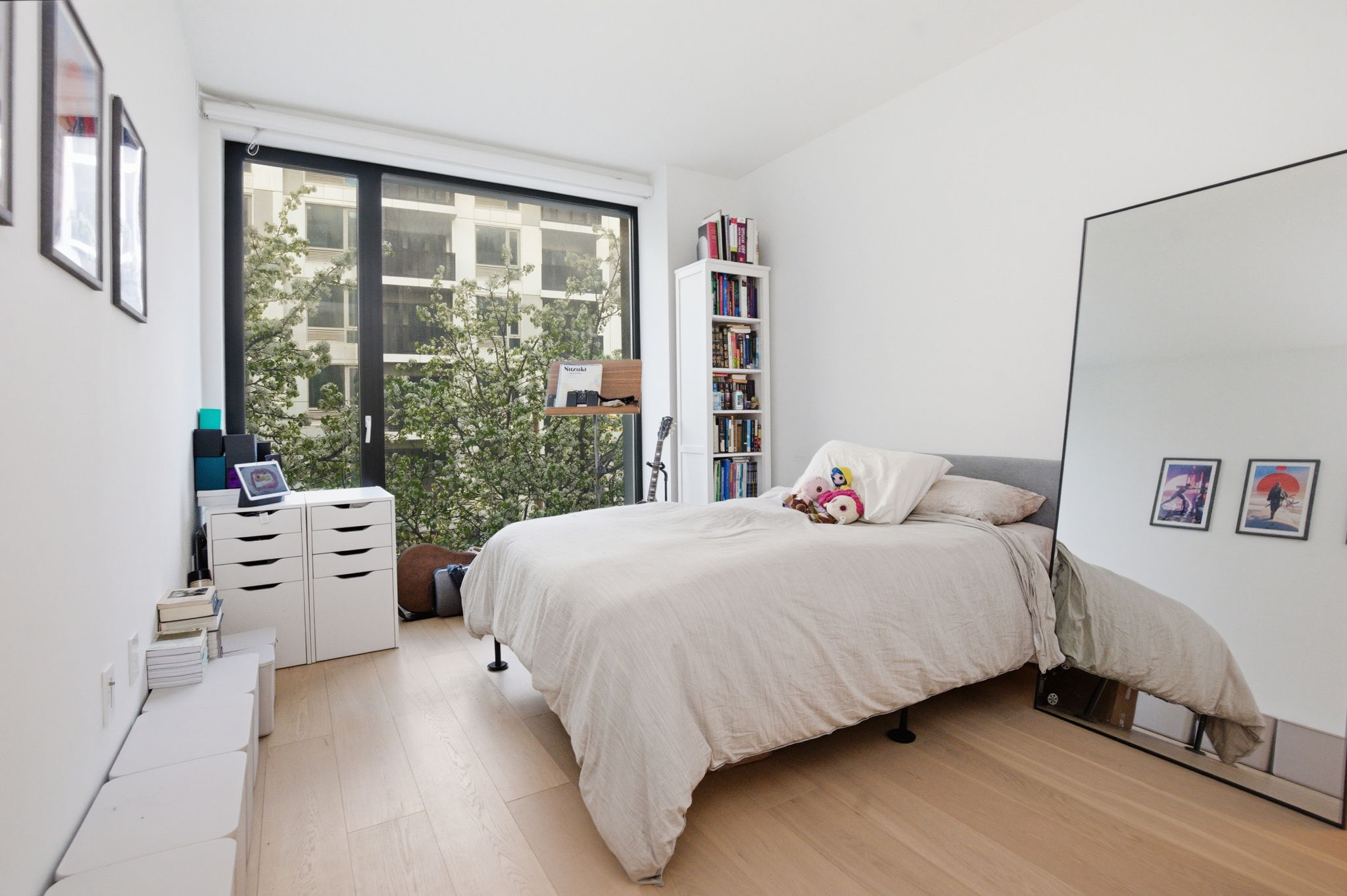 37-14 34th Street, Unit N3E Queens, NY 11101 - Photo 9 of 18 a bedroom with a bed and a large window