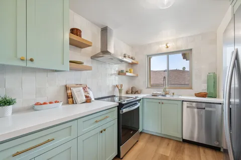 a kitchen with cabinets a sink and appliances