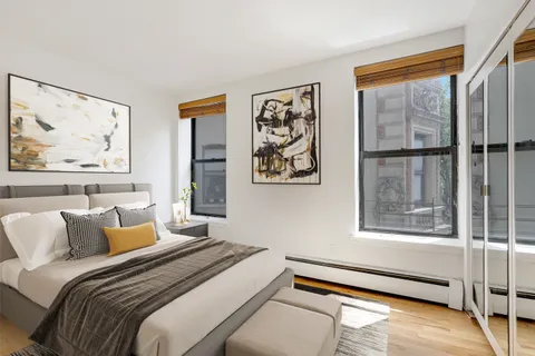 a bedroom with a bed and glass window