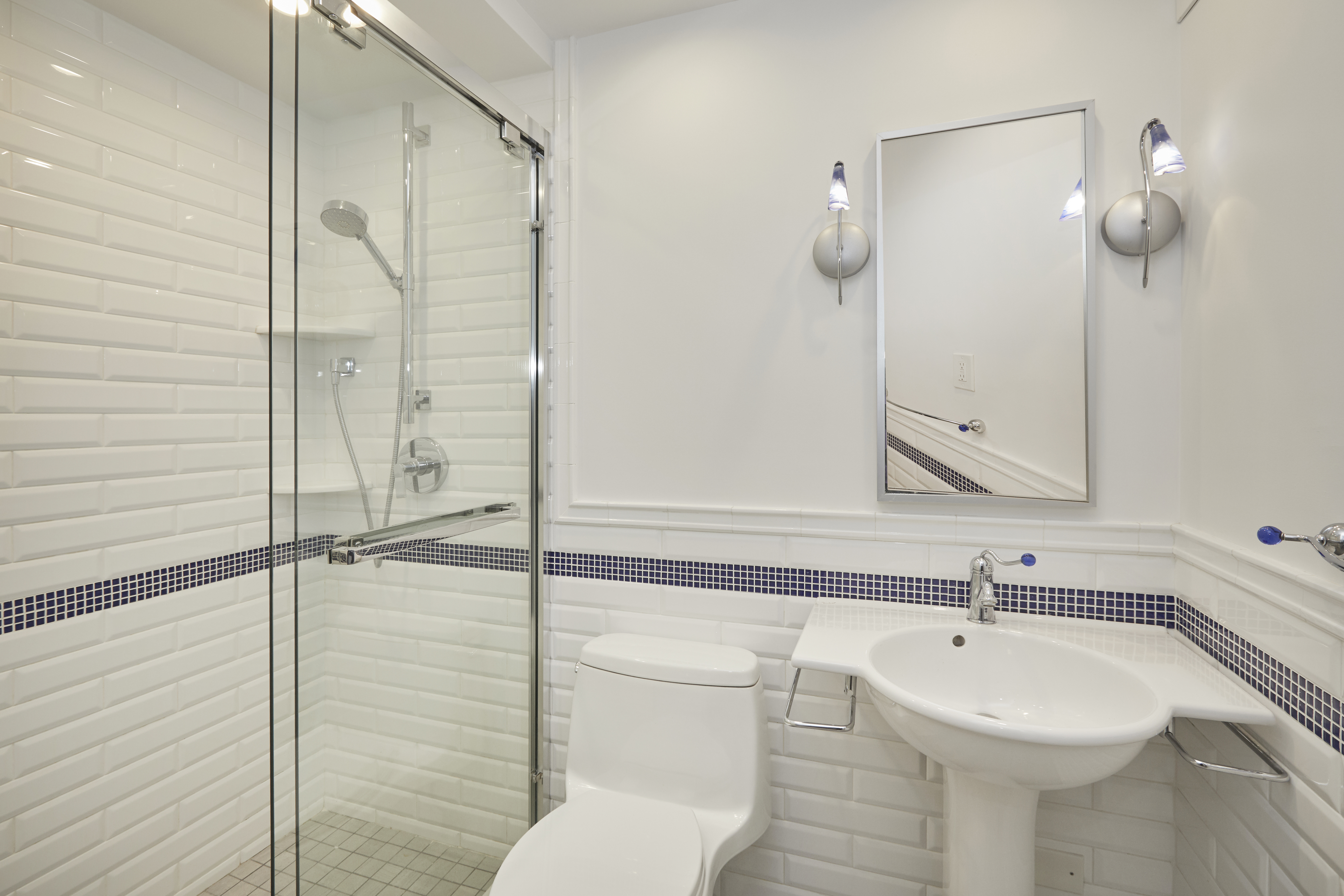 309 East 49th Street, Unit 3D Manhattan, NY 10017 - Photo 9 of 11 a bathroom with a sink a toilet and shower