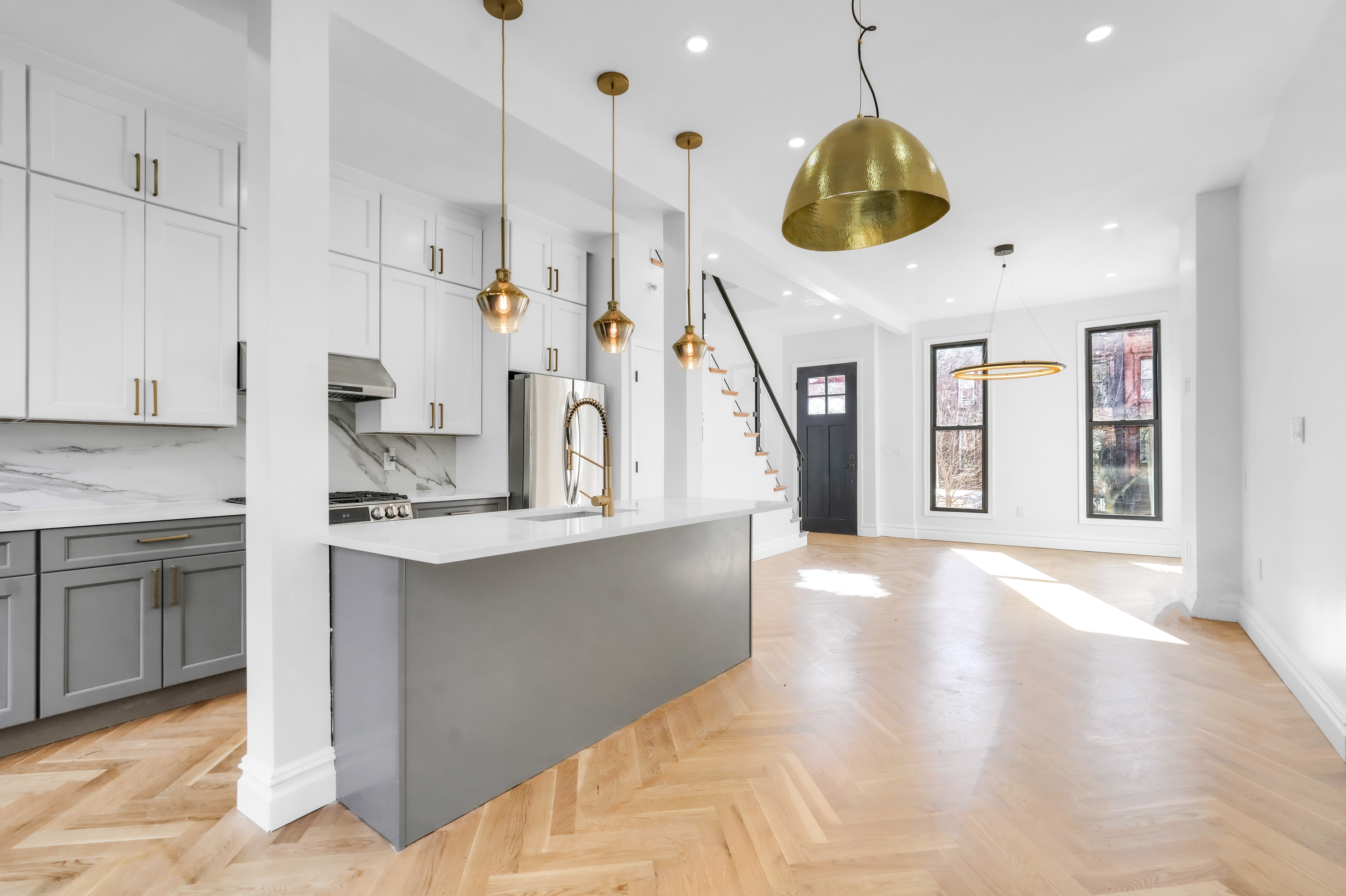 473 Monroe Street Brooklyn, NY 11221 - Photo 14 of 40 a large kitchen with stainless steel appliances kitchen island a large counter space a sink a window and stainless steel appliances