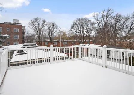 a view of a balcony with wooden fence