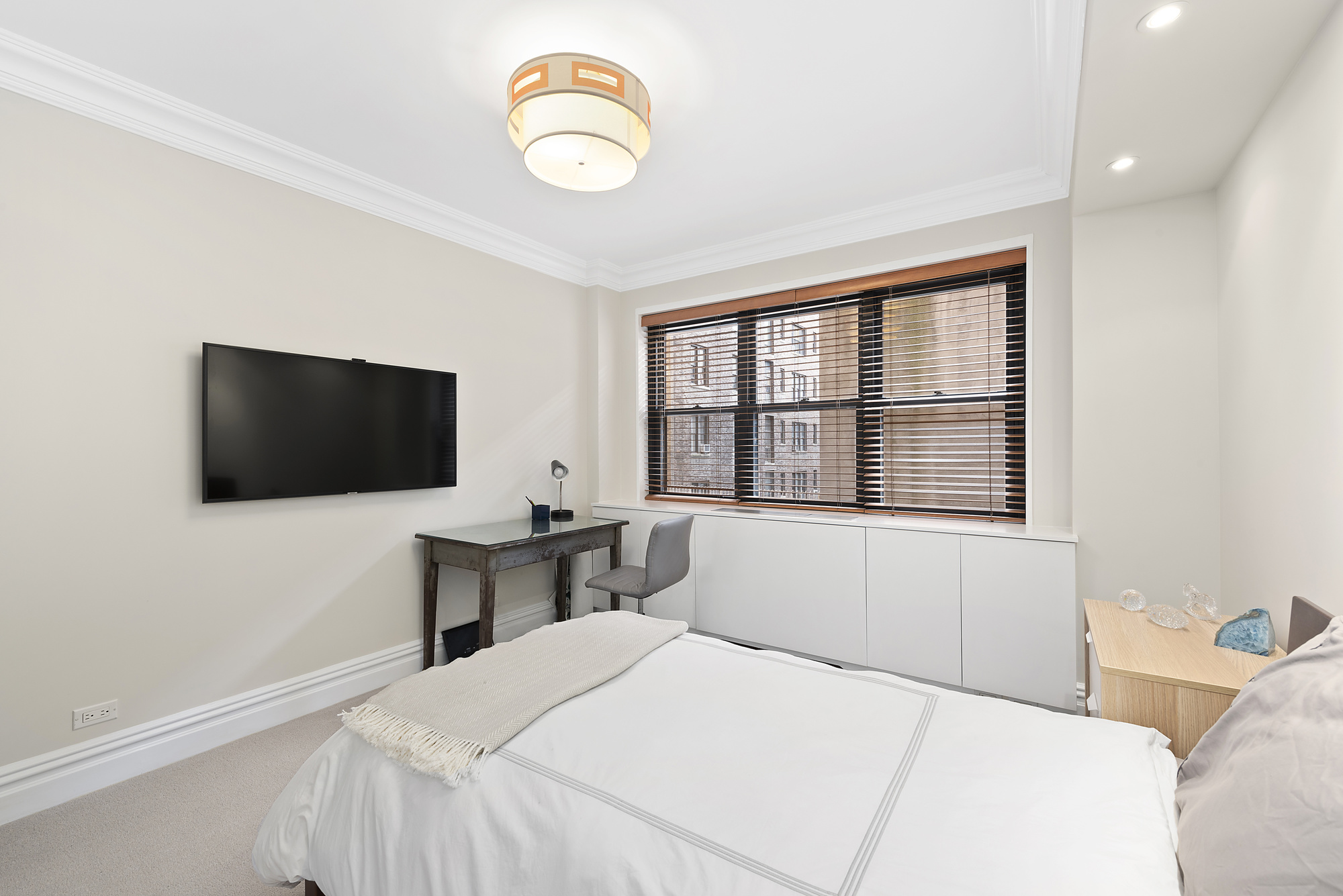 165 East 72nd Street, Unit 3L Manhattan, NY 10021 - Photo 8 of 13 a bedroom with a bed and a flat screen tv