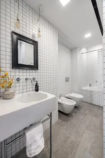 a bathroom with a sink double vanity and a tub