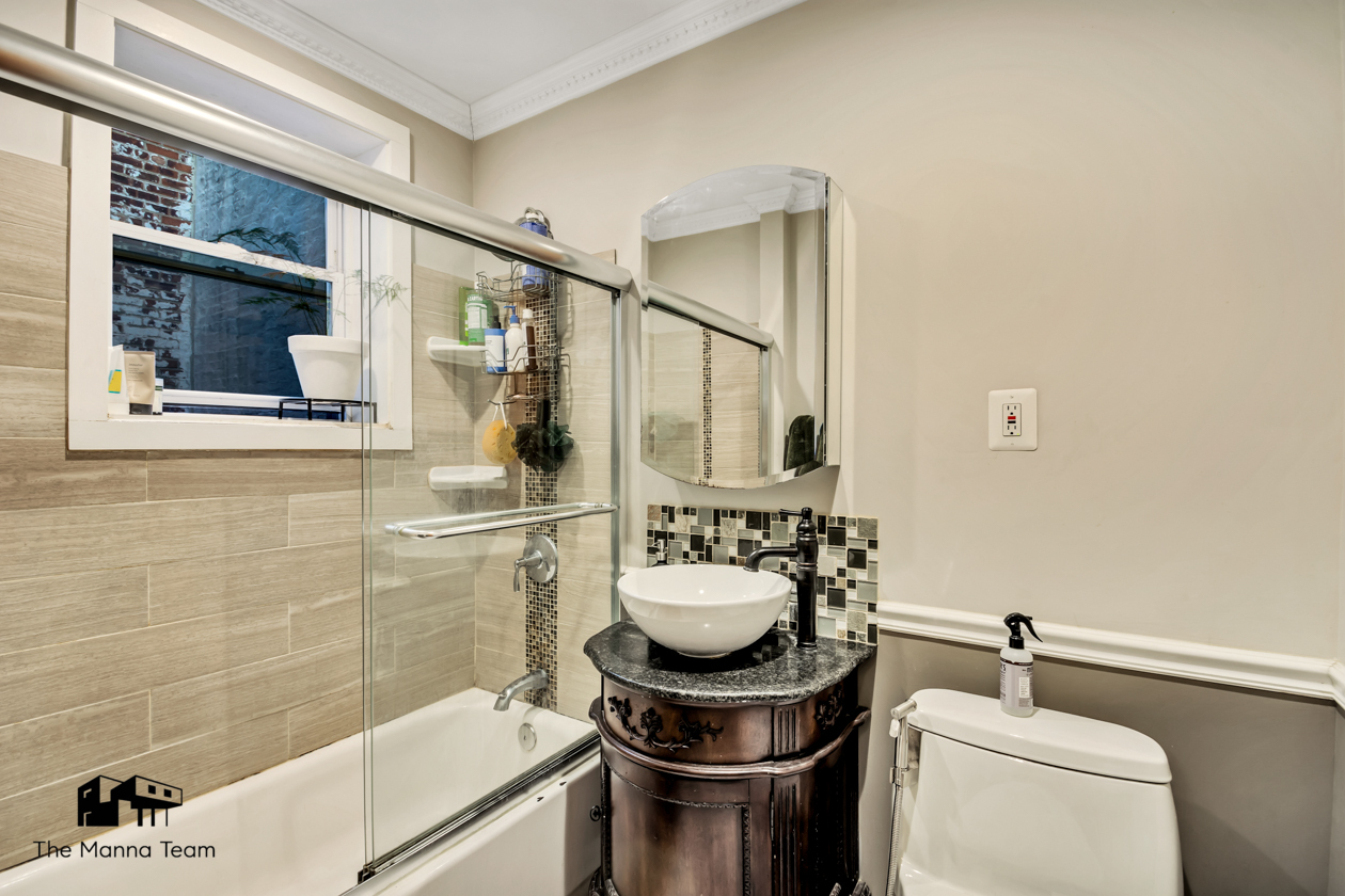 495 Lorimer Street Brooklyn, NY 11211 - Photo 16 of 24 a bathroom with a sink a toilet and shower