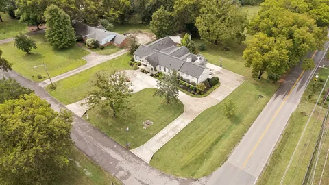 aerial view of a house with outdoor space and a swimming pool