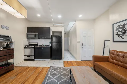 a kitchen with stainless steel appliances kitchen island granite countertop a refrigerator and a stove top oven