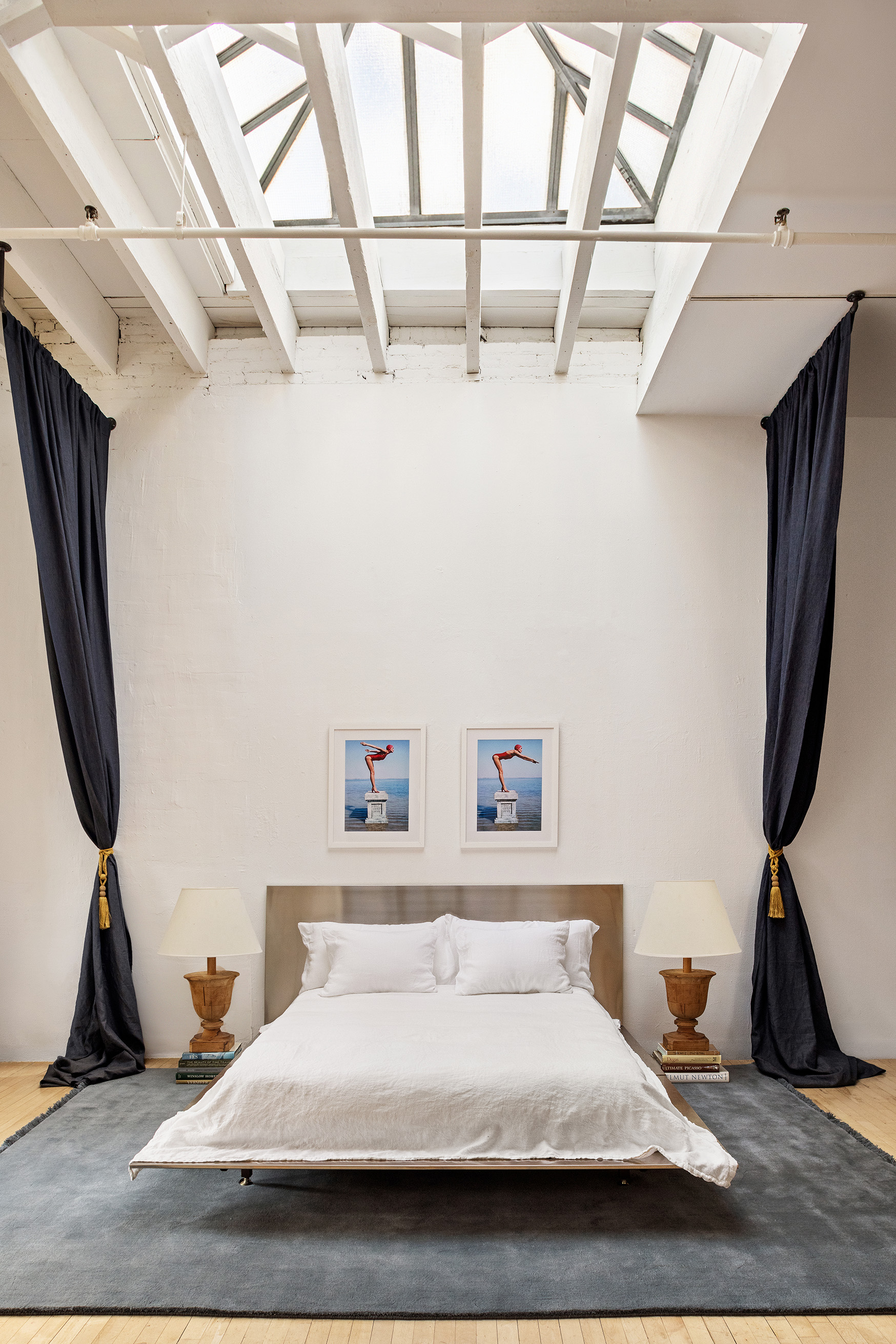 47 Howard Street, Unit PH Manhattan, NY 10013 - Photo 2 of 14 a bedroom with a bed a dresser and a flat screen tv
