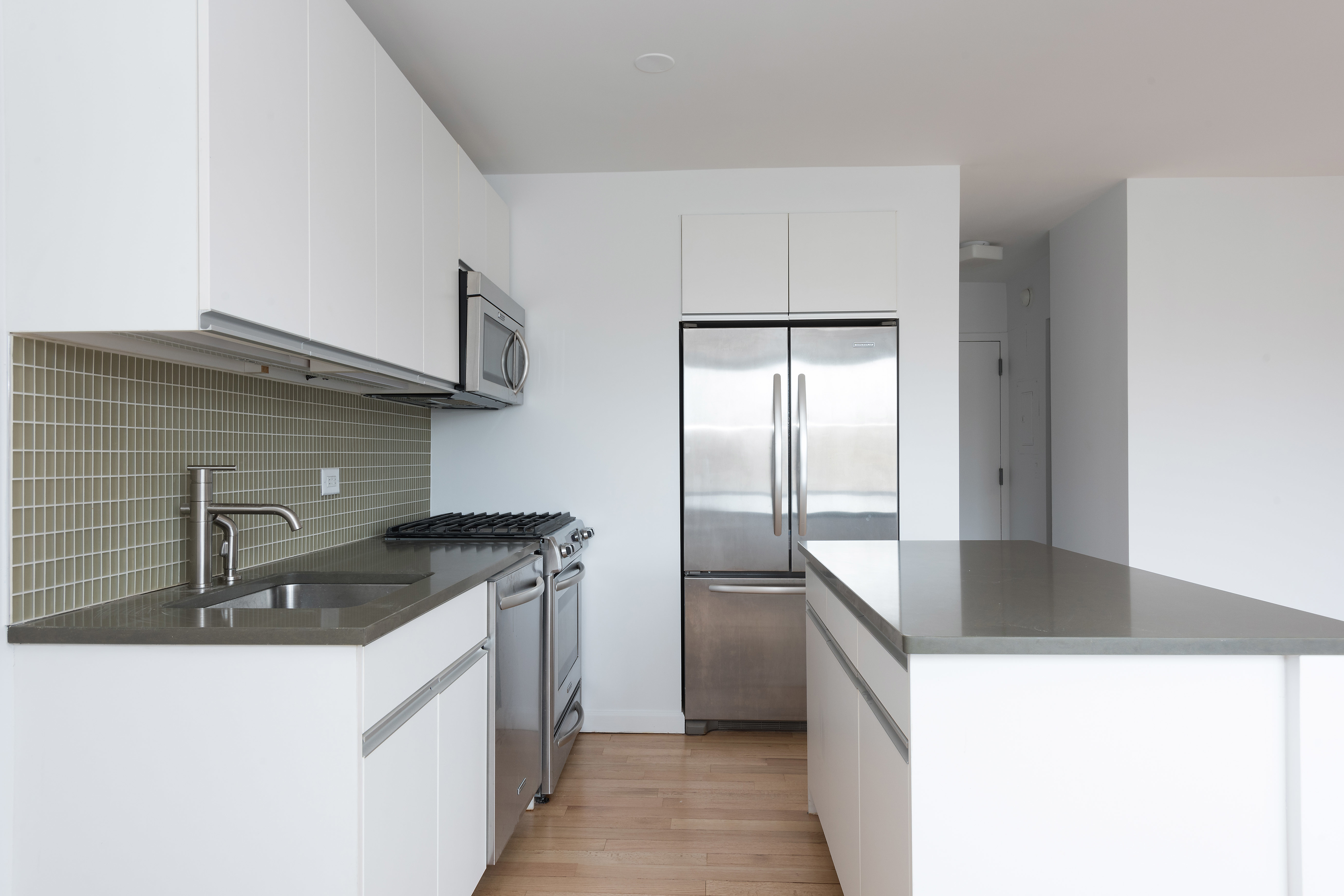 100 West 93rd Street, Unit 10D Manhattan, NY 10025 - Photo 3 of 9 a kitchen that has a sink and a stove