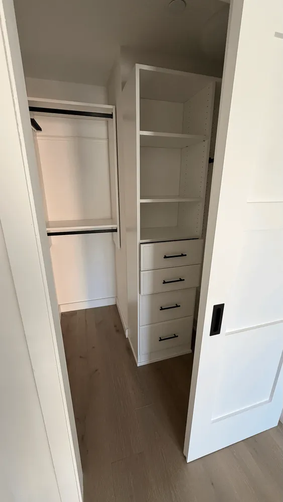 a view of walk in closet with empty racks