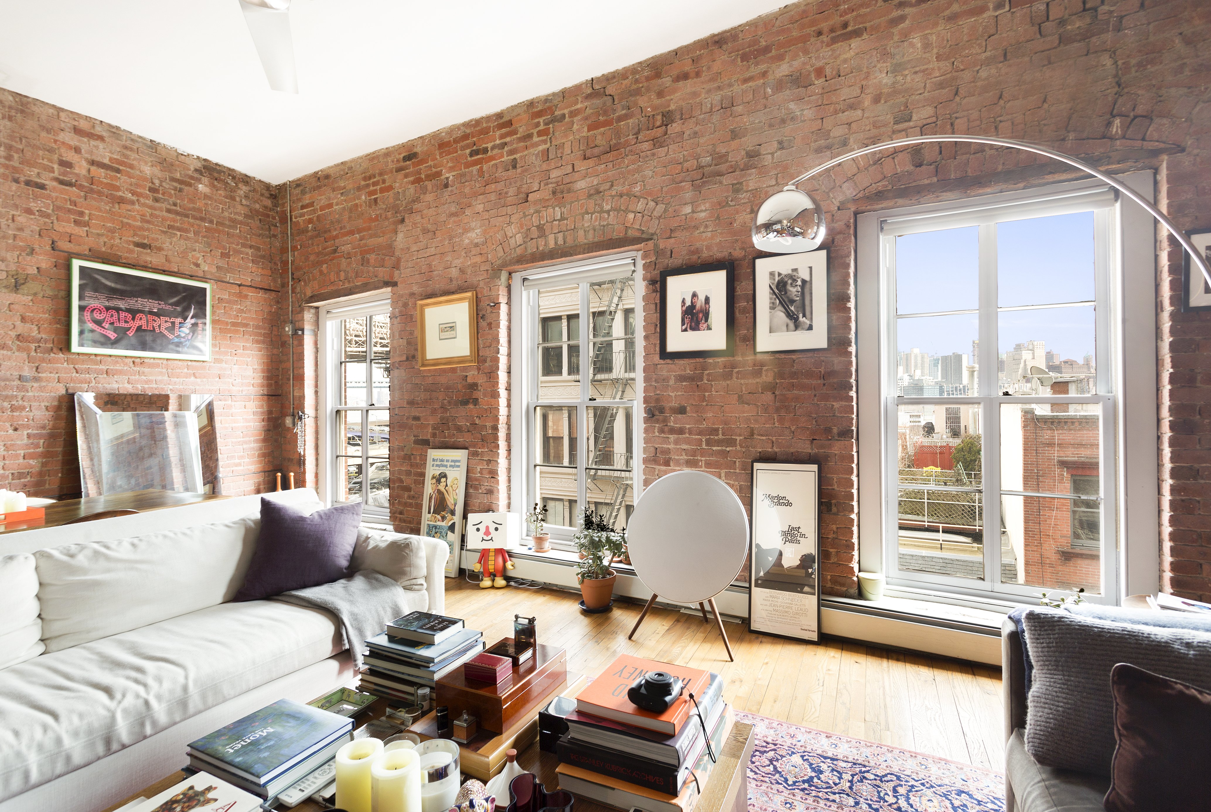 272 Water Street, Unit 5F Manhattan, NY 10038 - Photo 4 of 12 a living room with furniture a table and large windows