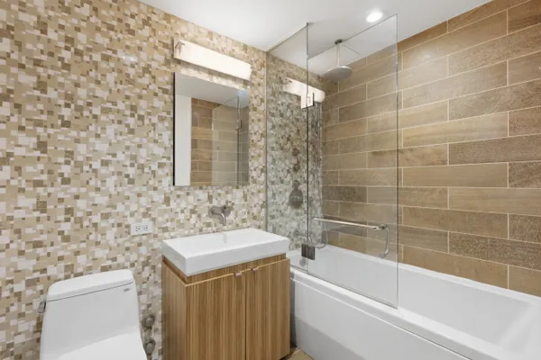 a bathroom with a sink a toilet and bathtub