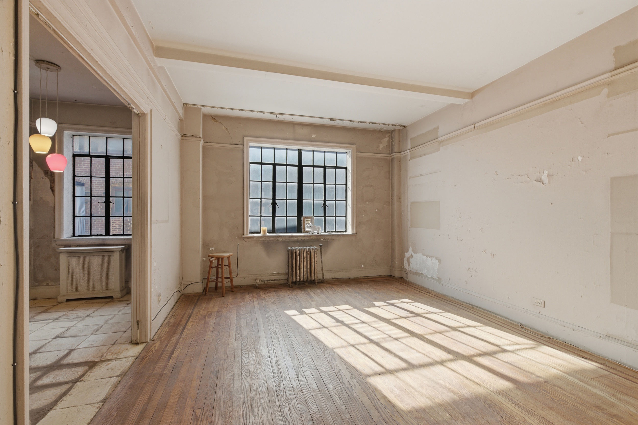 210 West 78th Street, Unit 8C Manhattan, NY 10024 - Photo 2 of 21 an empty room with wooden floor and windows