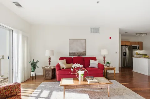 a living room with furniture and wooden floor