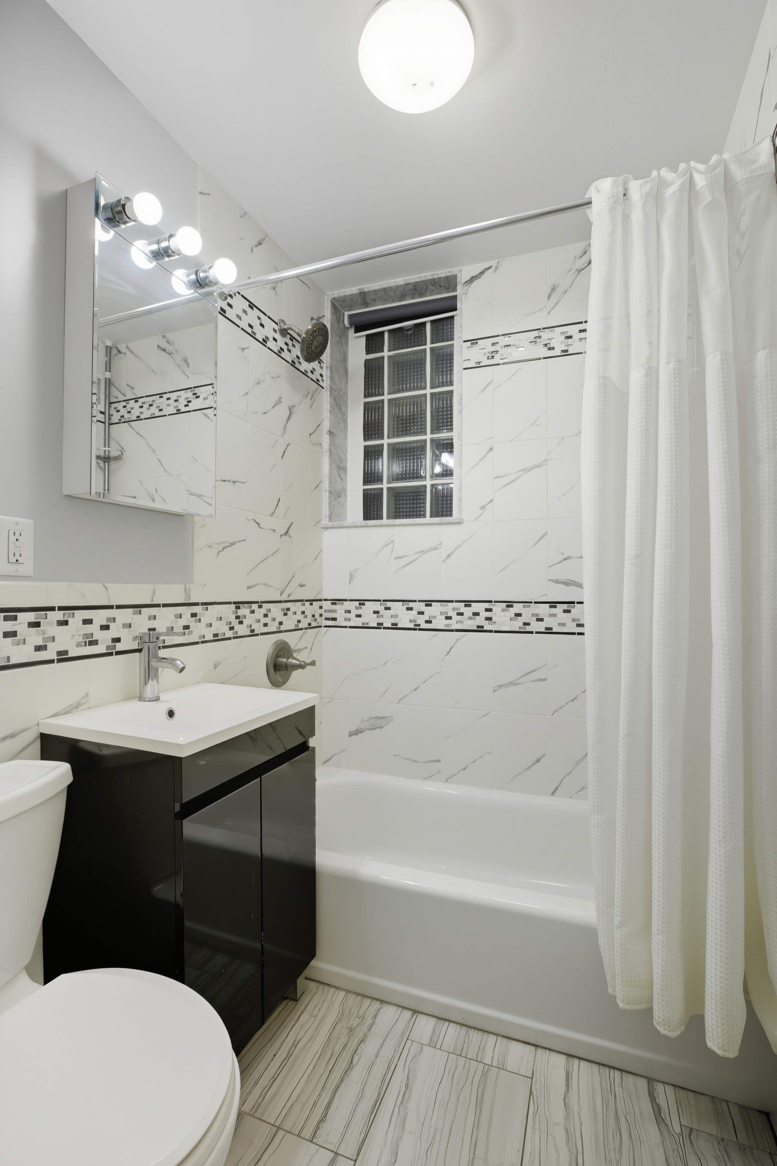 130 Hicks Street, Unit 1E Brooklyn, NY 11201 - Photo 6 of 12 a bathroom with a sink a toilet and shower