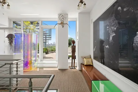 a view of a hallway and a livingroom with furniture