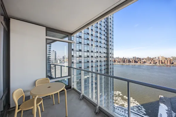 a balcony with table and chairs