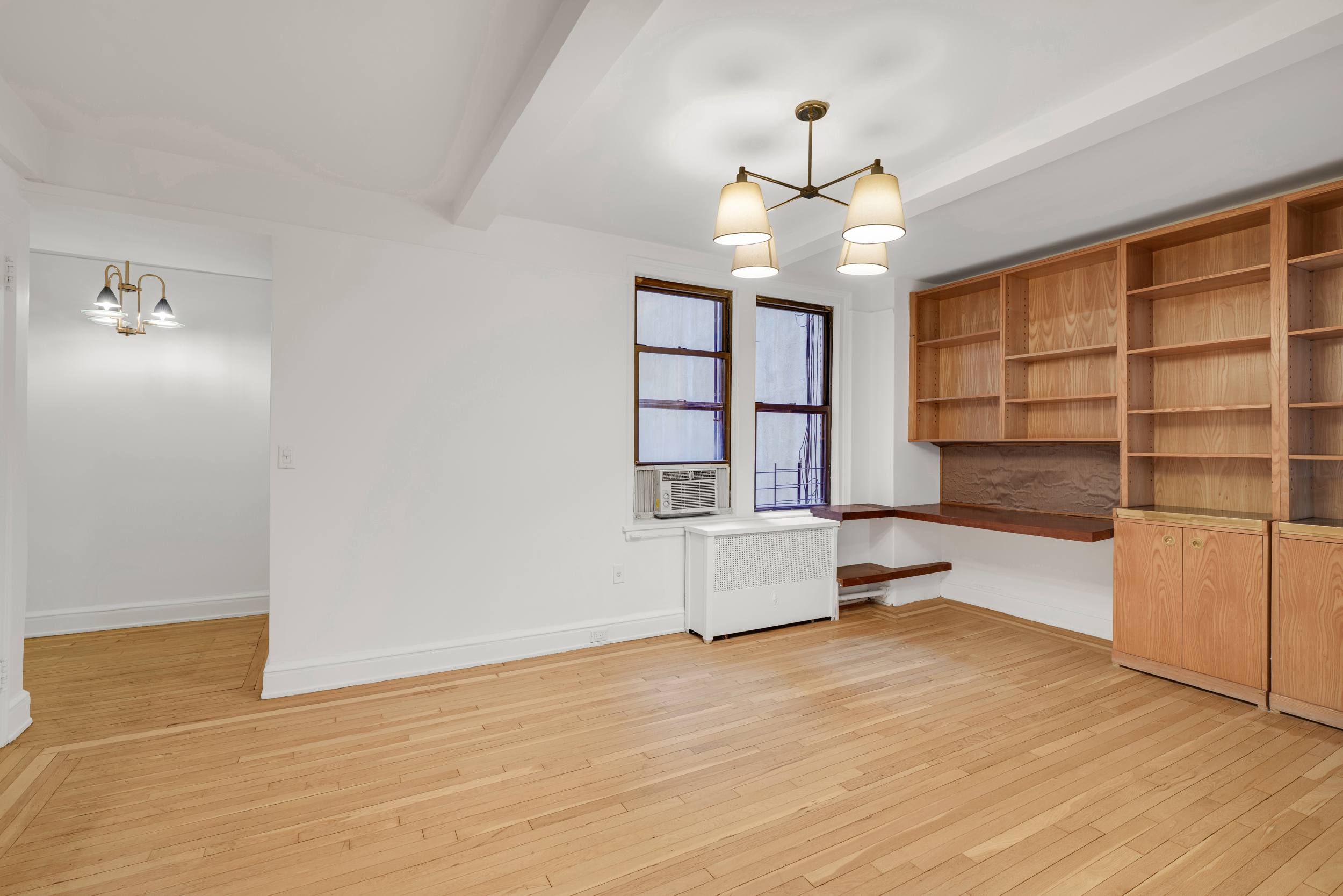 74 West 68th Street, Unit 5A Manhattan, NY 10023 - Photo 17 of 25 an empty room with cabinet and windows