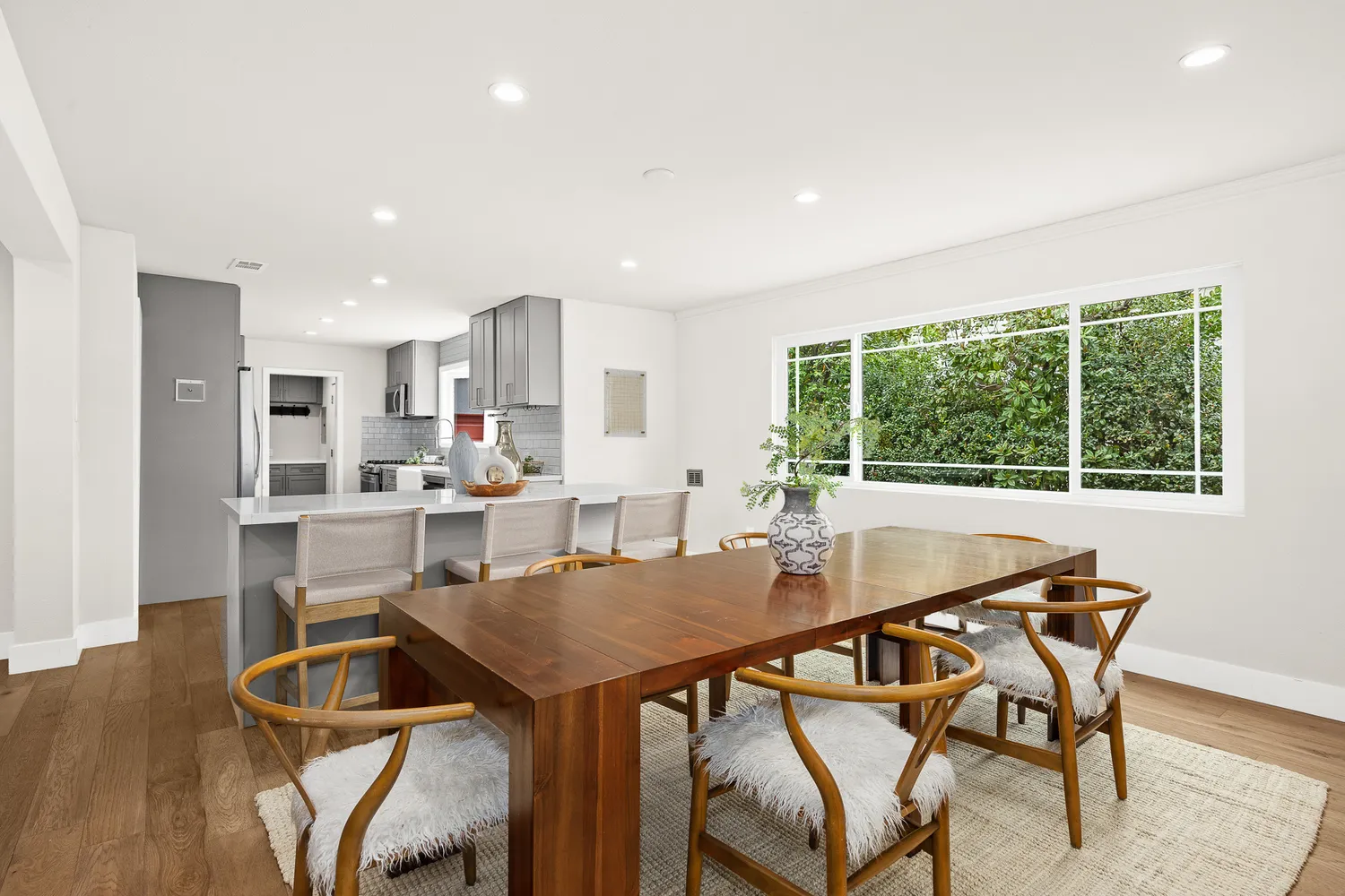a view of a dining room with furniture and windows
