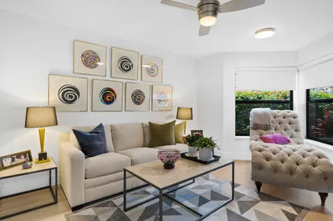 a living room with furniture and a wall painting