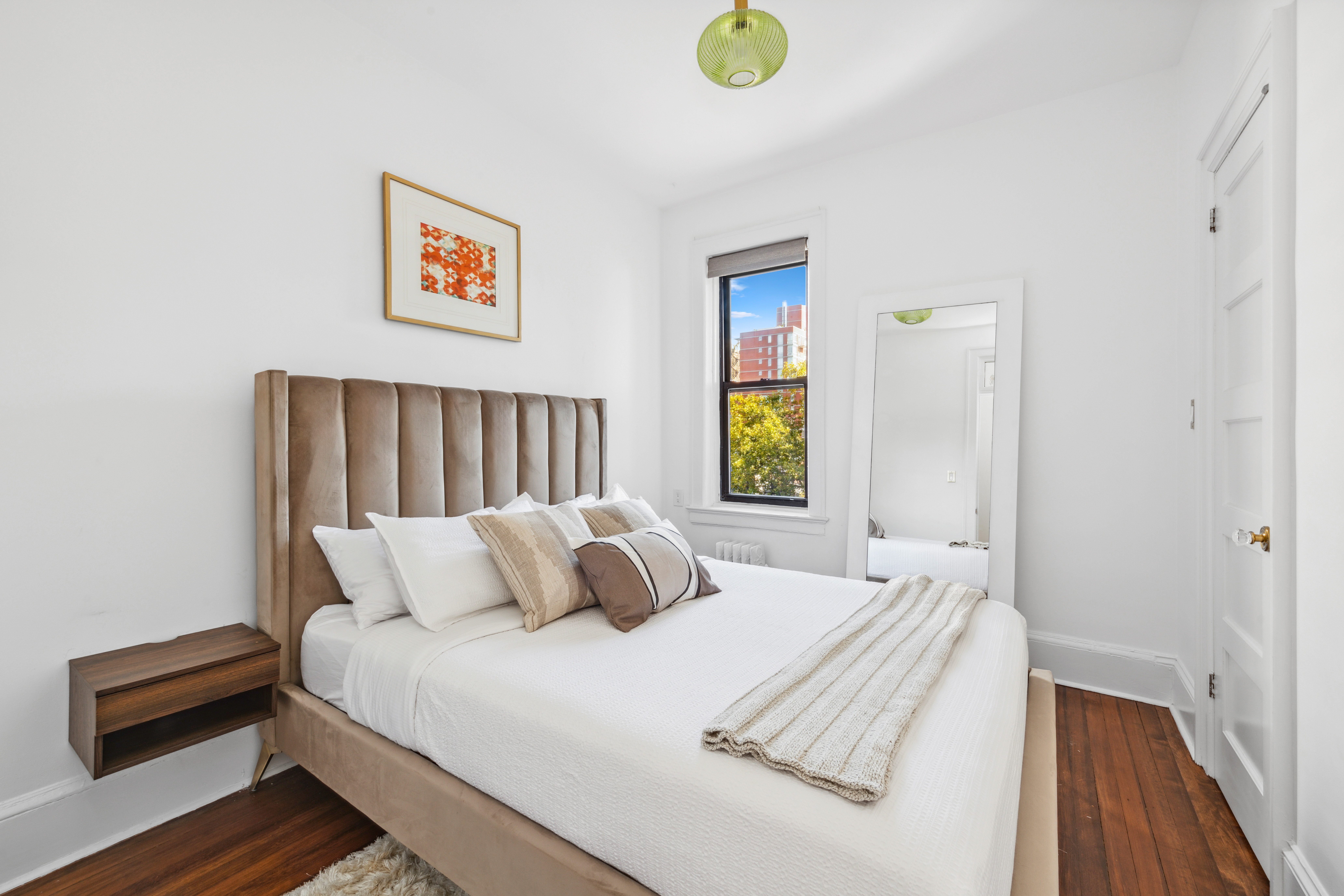 210 West 21st Street, Unit 6RE Manhattan, NY 10011 - Photo 6 of 13 a bedroom with a bed and painting on the wall