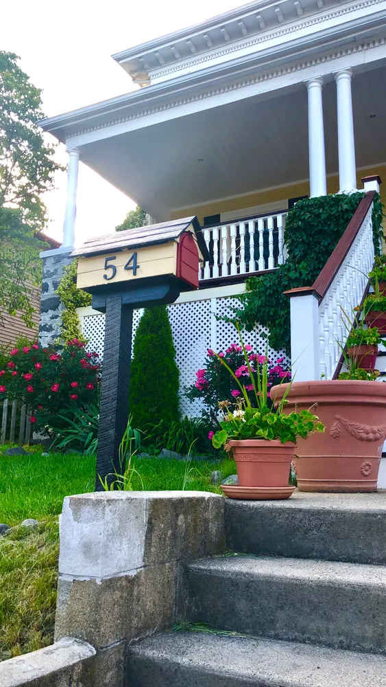 a wooden bench sitting in front of a house