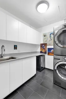 a utility room with sink dryer and washer