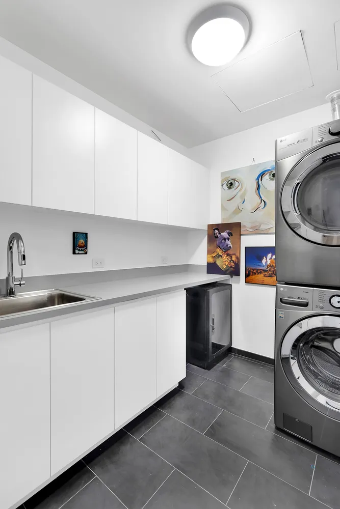 a utility room with sink dryer and washer