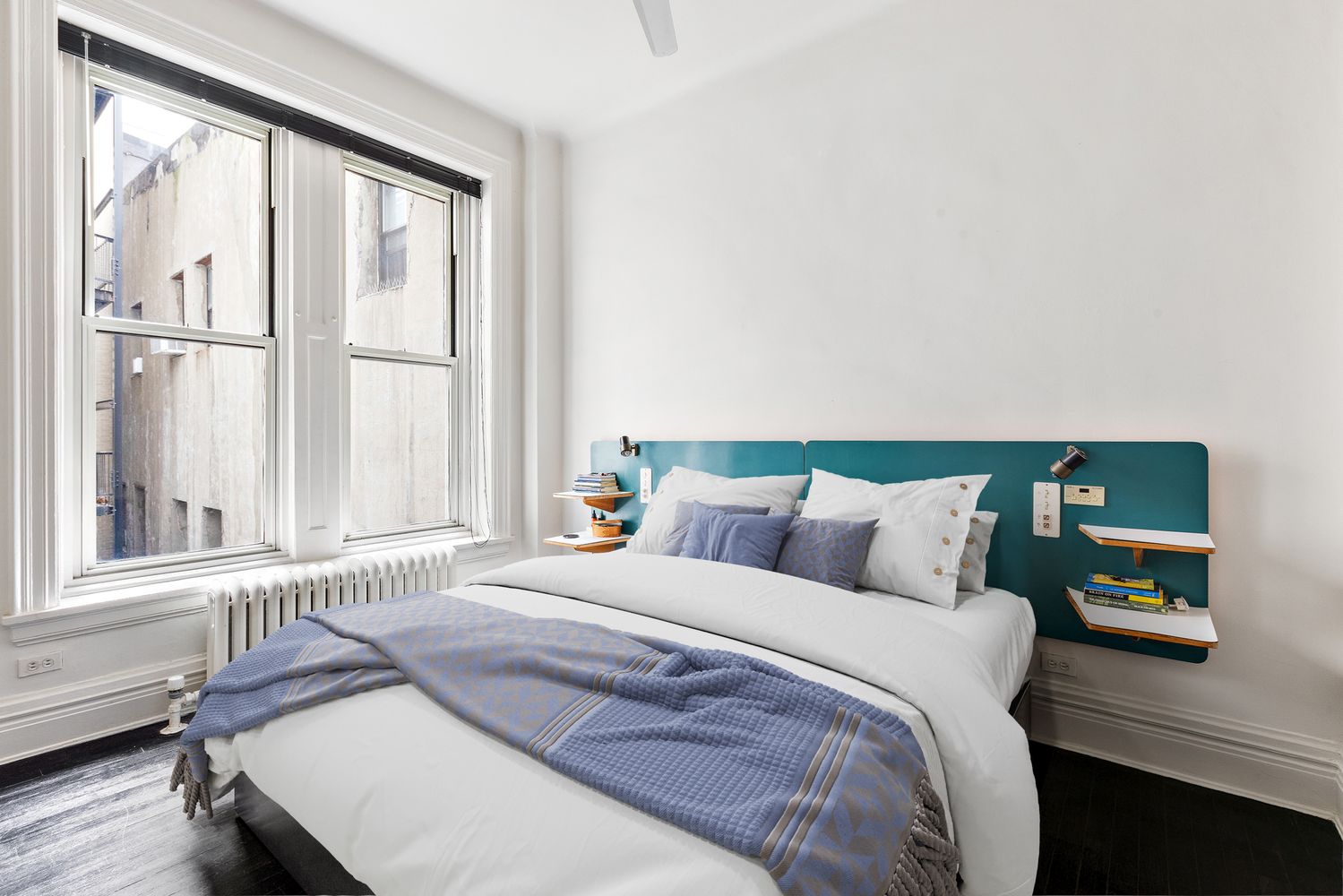 366 Broadway, Unit 5C Manhattan, NY 10013 - Photo 13 of 18 a bed sitting in a bedroom next to a window