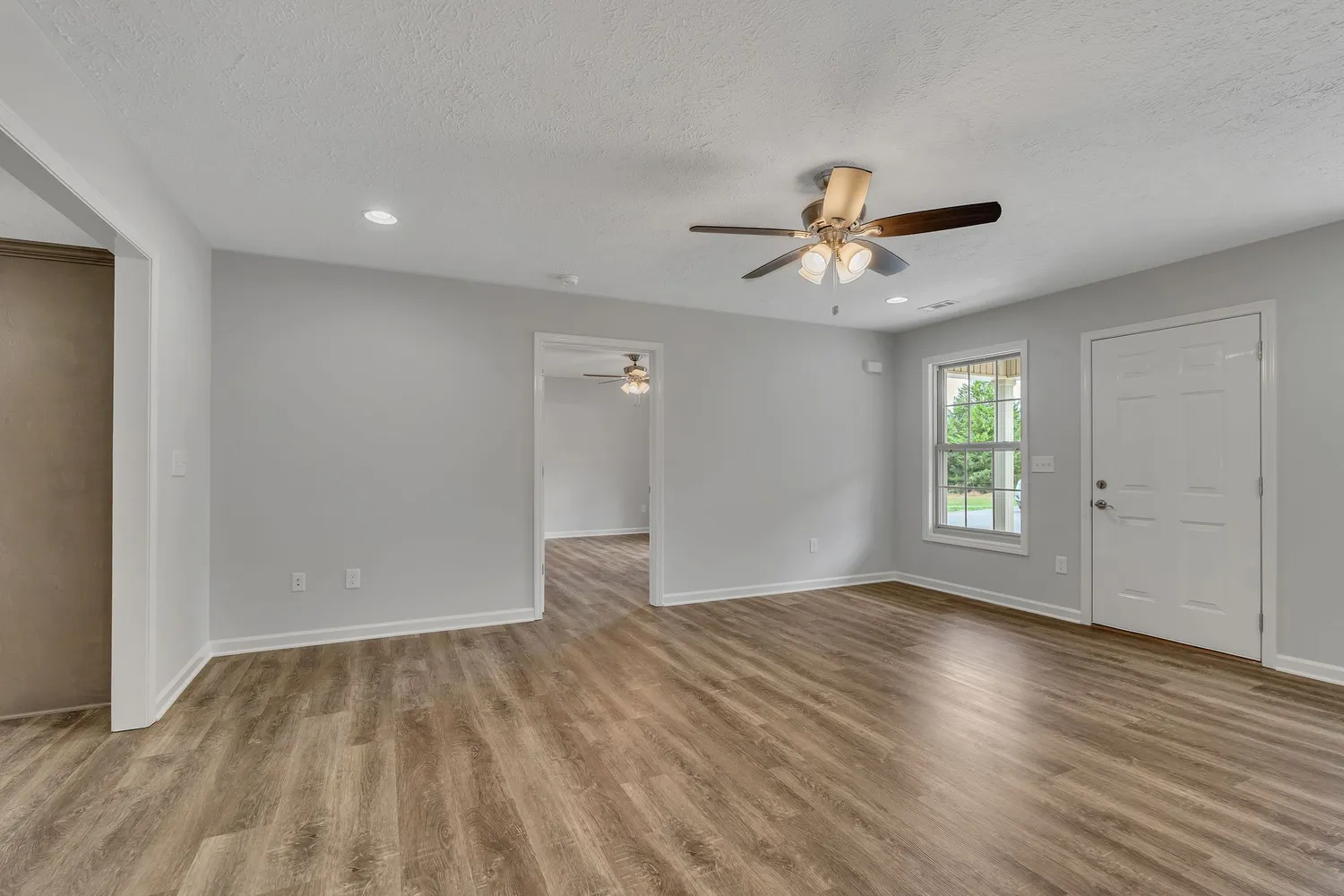 wooden floor in an empty room with a window