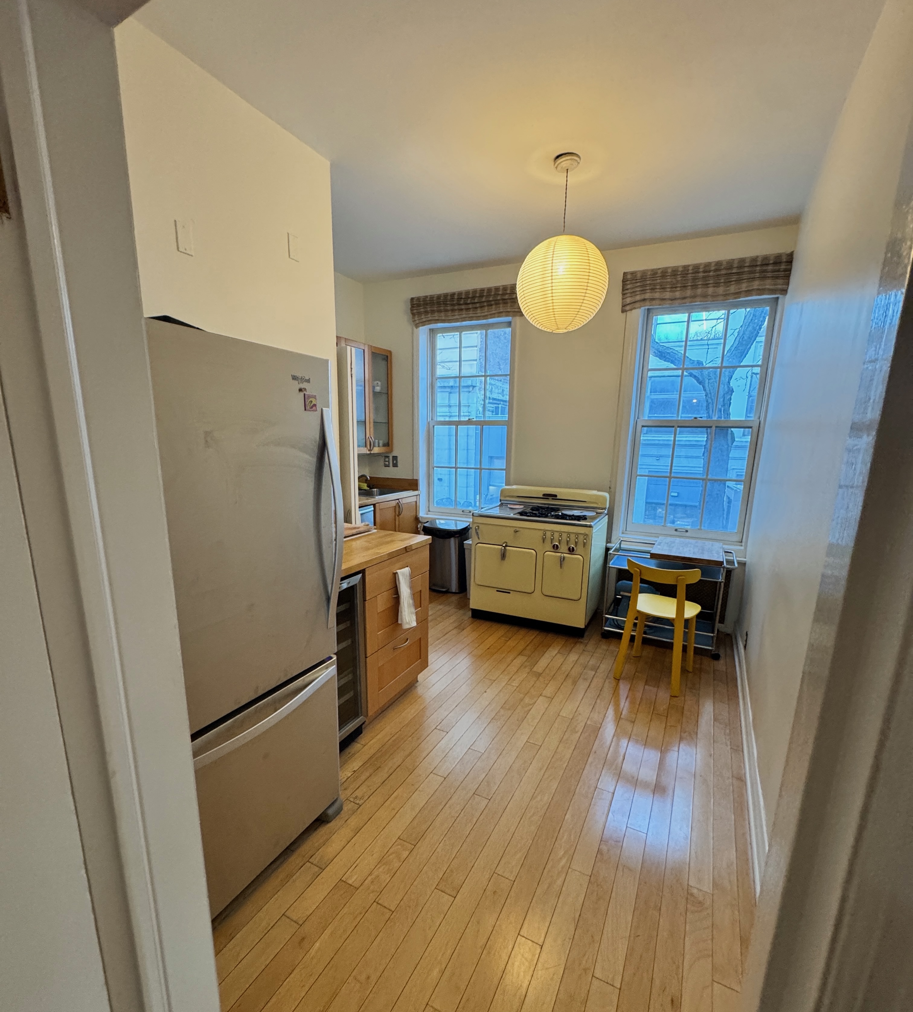 19 Vandam Street, Unit 2 Manhattan, NY 10014 - Photo 15 of 19 a kitchen with a refrigerator and a table