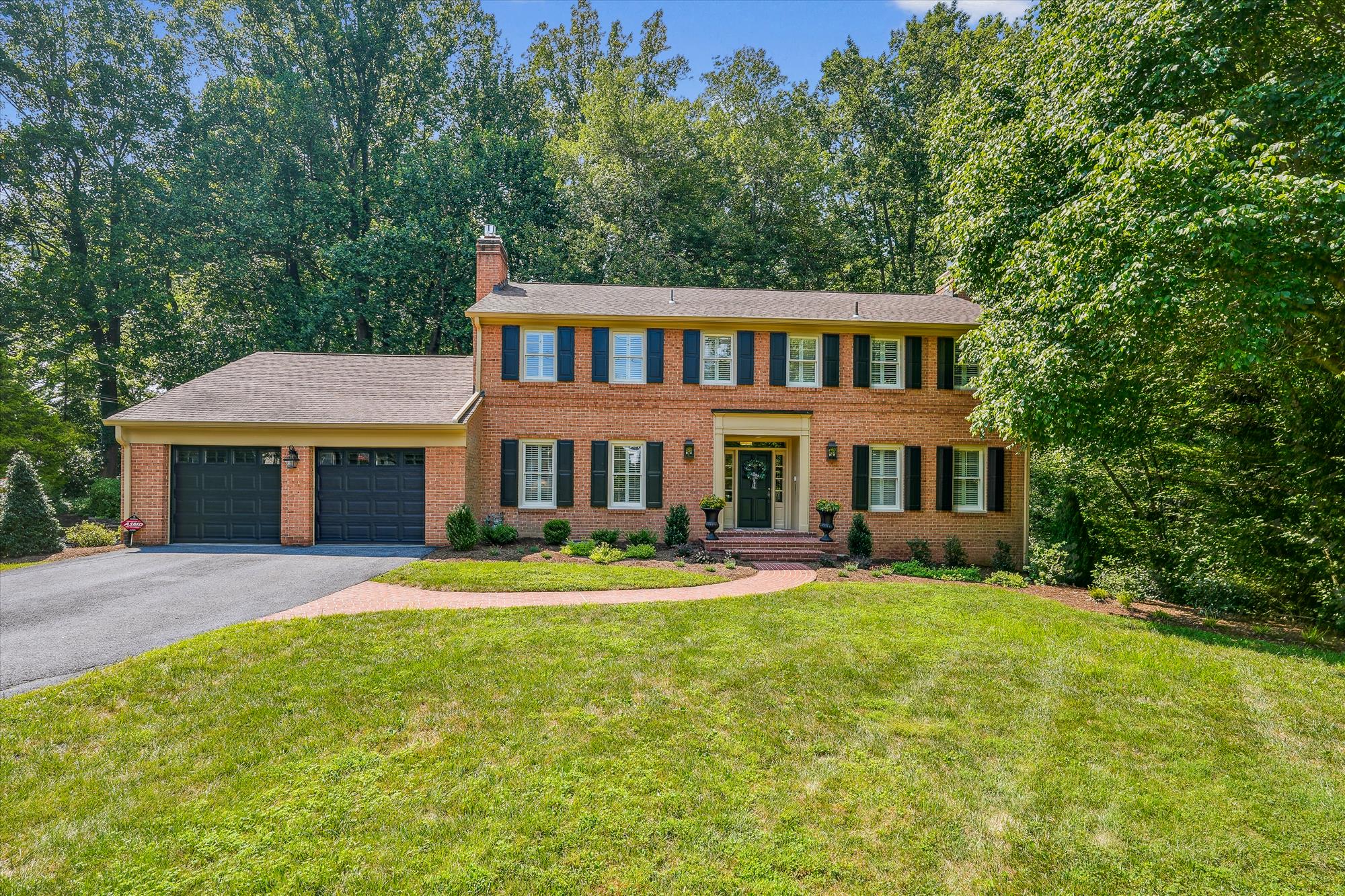 a front view of a house with a yard table and chairs