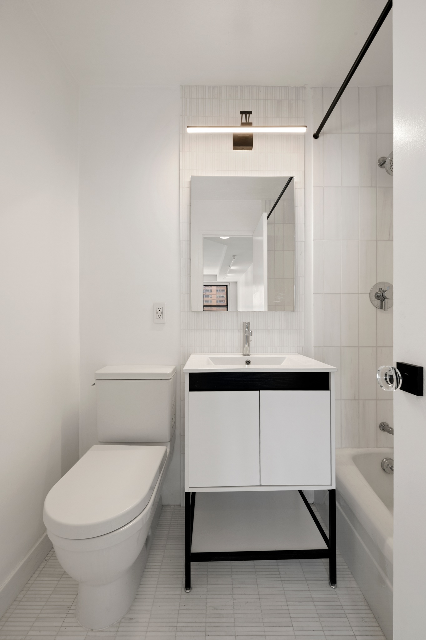 155 West 68th Street, Unit 1410 Manhattan, NY 10023 - Photo 10 of 11 a bathroom with a toilet a sink and a bathtub
