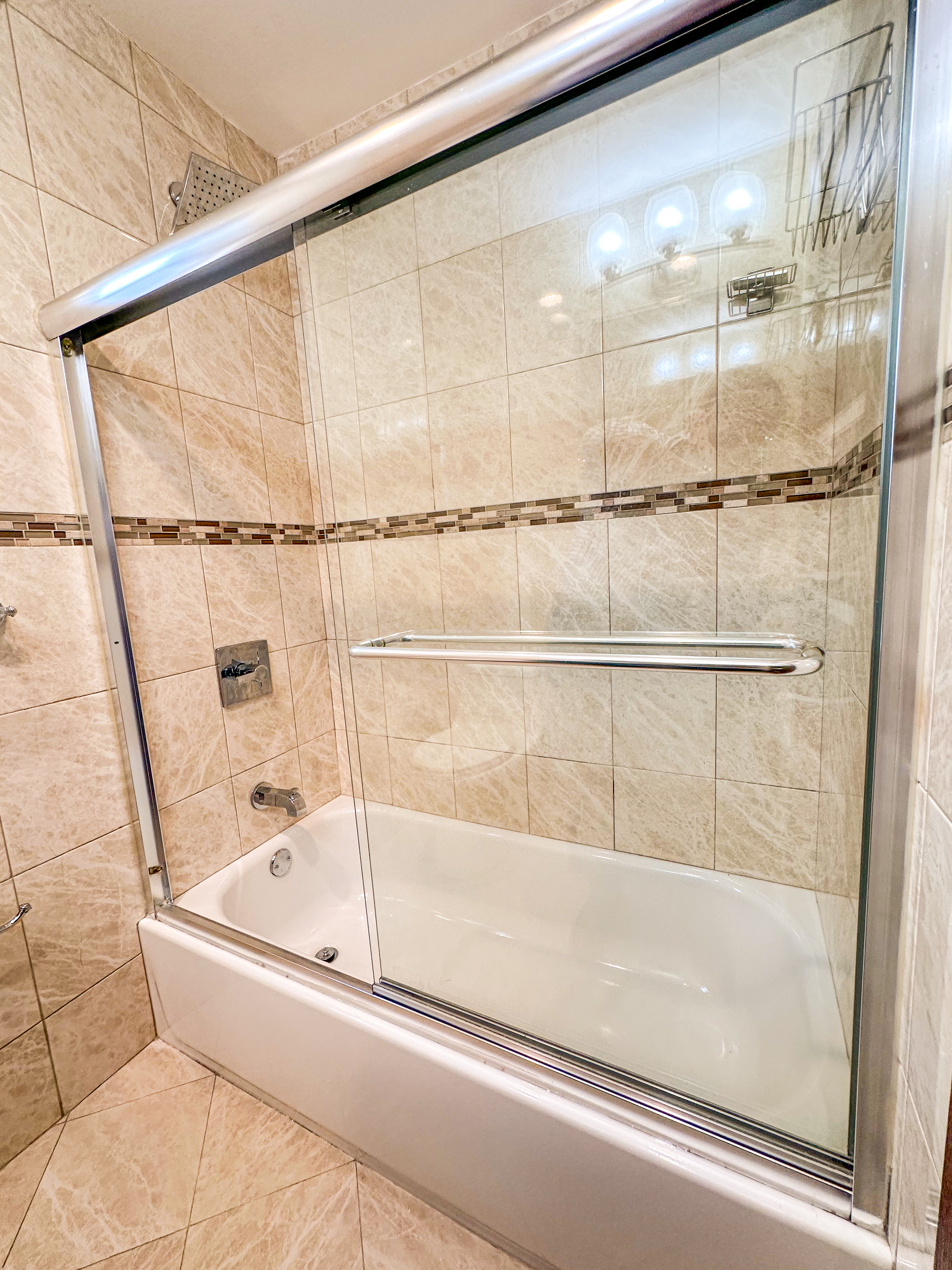 10-01 154th Street, Unit 1 Queens, NY 11357 - Photo 4 of 10 a bathroom with a bathtub and shower