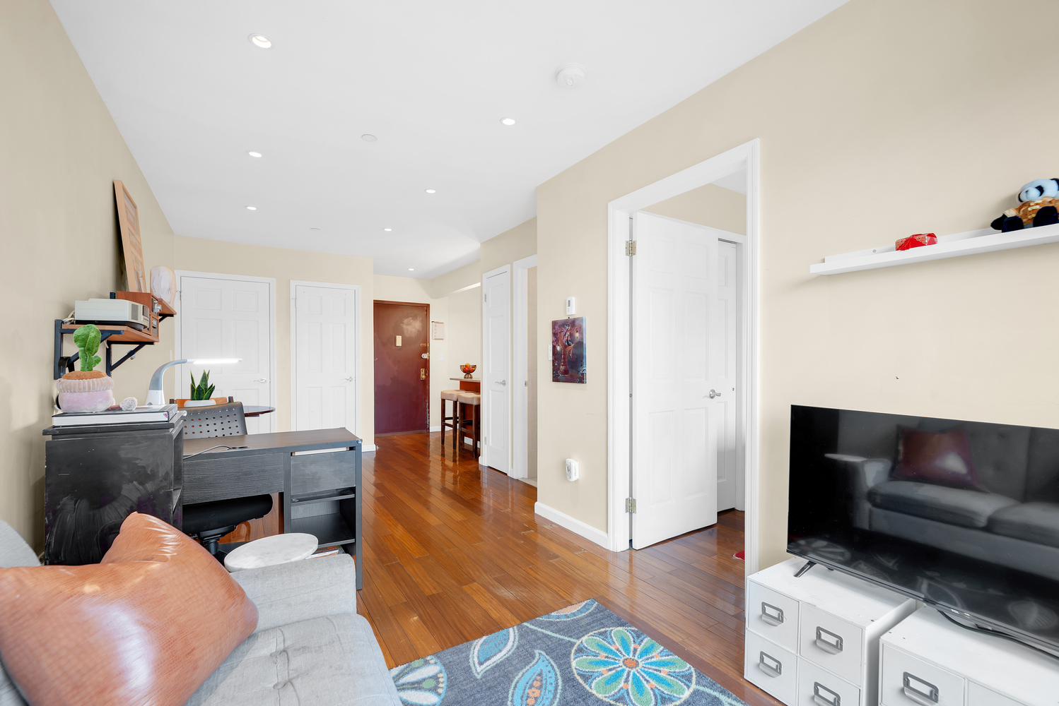 43-33 42nd Street, Unit 6B Queens, NY 11104 - Photo 2 of 8 a living room with furniture and wooden floor