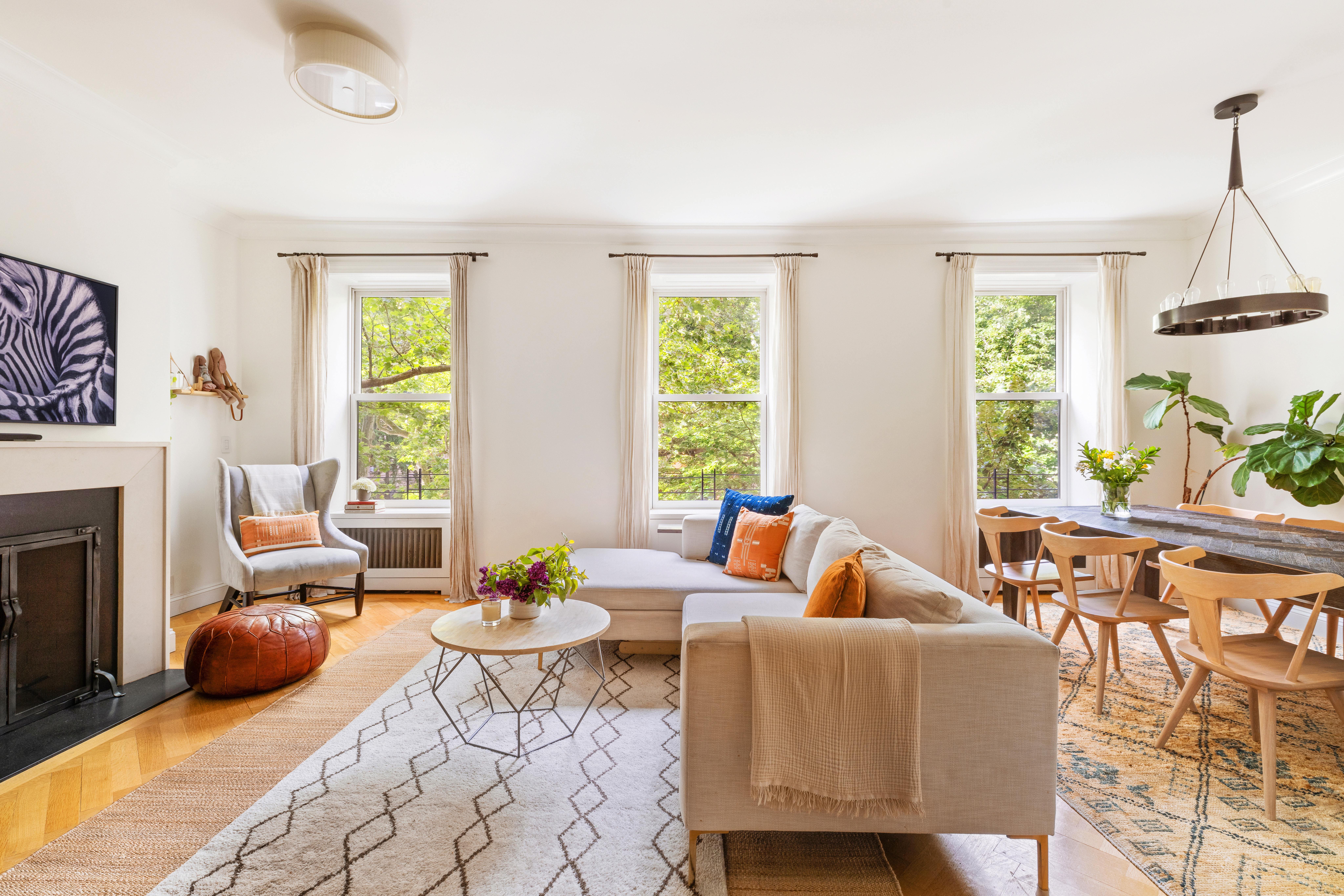 a living room with furniture a fireplace and a potted plant