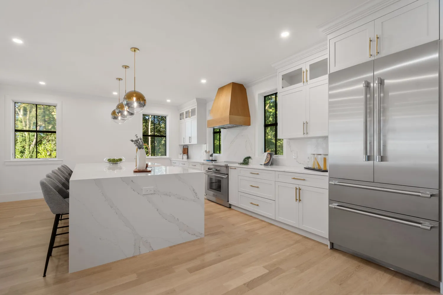 a large kitchen with kitchen island a counter space a sink a window and stainless steel appliances